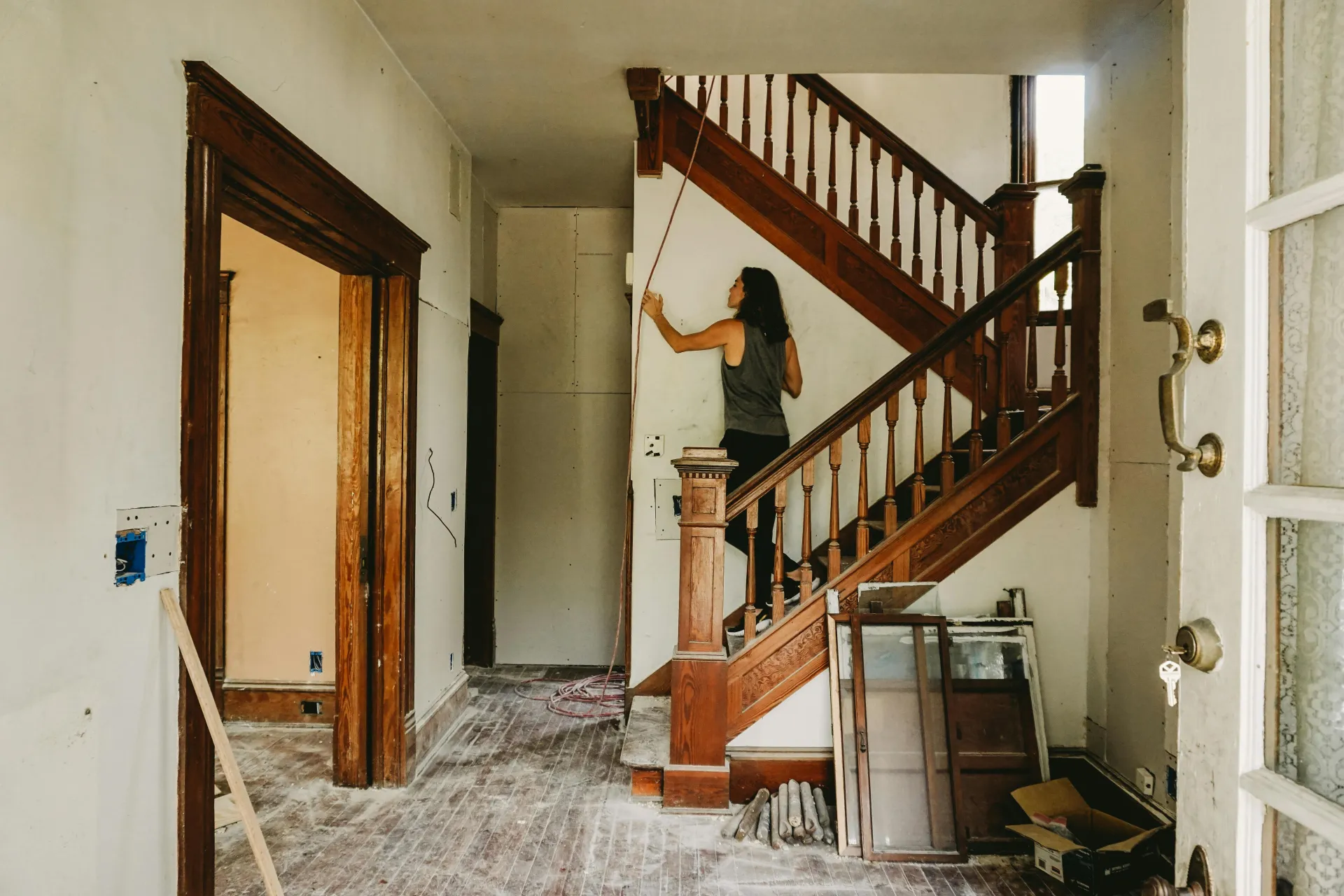 Home renovation in progress with exposed staircase
