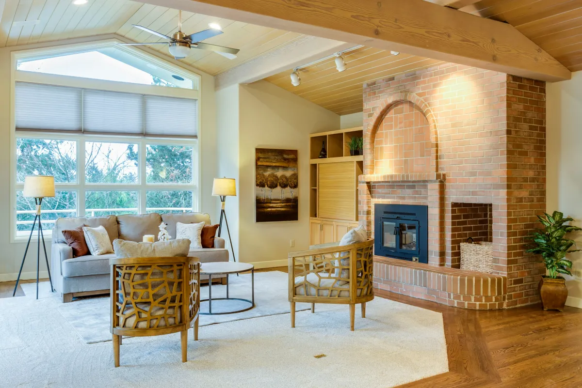 Warm living room with brick fireplace and natural light